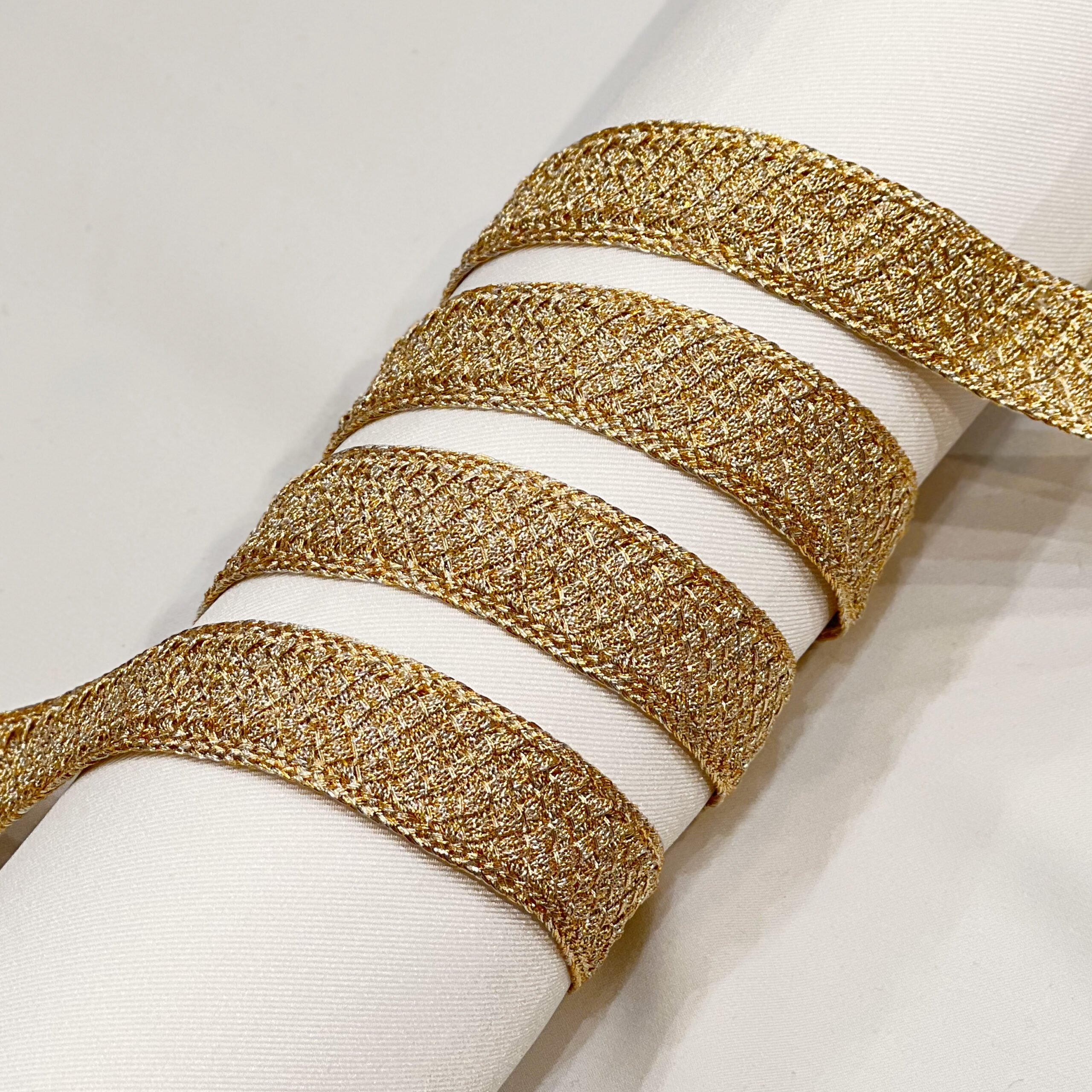 Luxury white fabric with gold metallic woven trim, featuring an elegant textured design for haute couture and evening wear